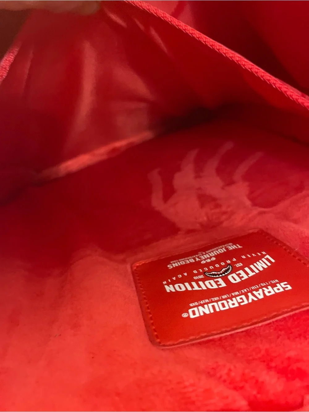 Sprayground Metallic Silver Logo Backpack with Red Accents